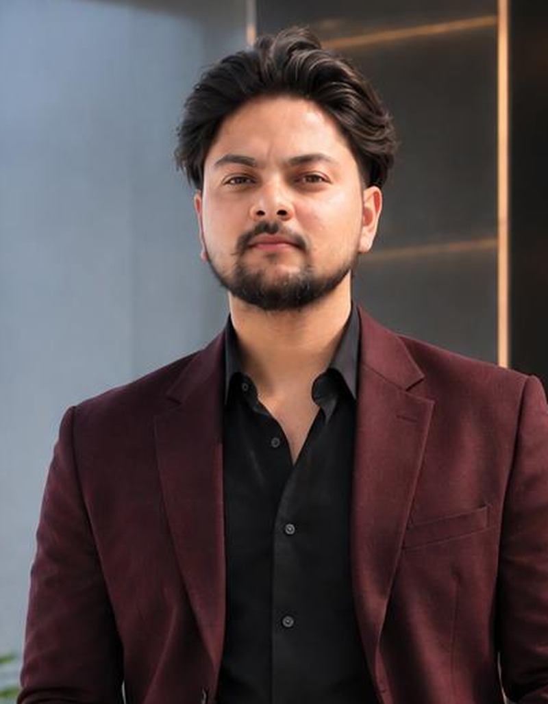 Professional passport-style headshot of Vishal Choudhary, Senior Full Stack Developer, wearing a brown suit with a white shirt and patterned tie